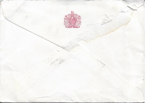 Back of an old envelope bearing a red stamp of the Royal crest.