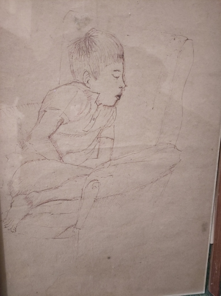 Sketch in ballpoint pen of a boy about 8 years old, sleeping in an armchair. He is white with short dark hair, leaning against the chair back with his mouth open, his legs tucked underneath him and his hands in his lap.
