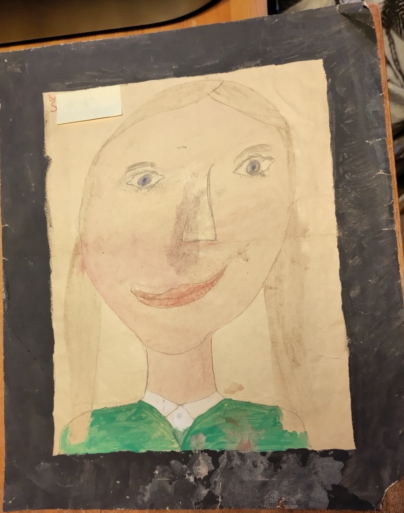 A child's painting of a white girl of about ten, with blue eyes, brown hair in bunches, and a green school uniform. 