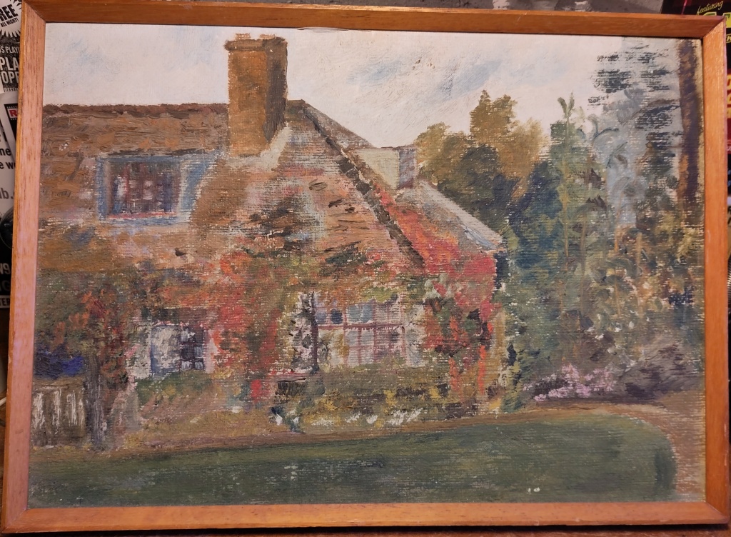 Oil painting of part of the front of a 1920s house with red tiled roof, square mullioned windows, russet coloured ivy and creepers over the roof and windows, a chimney stack and dormer window. There is a lawn and gravel drive  in front, and trees behind; the colours are autumnal shades of red, orange and green. 