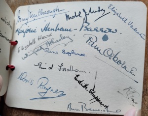A collection of handwritten signatures on a white card 