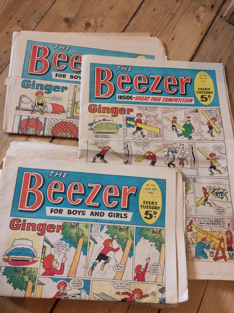 Several copies of Beezer comic from 1966, showing a cartoon character called Ginger on the front covers. 